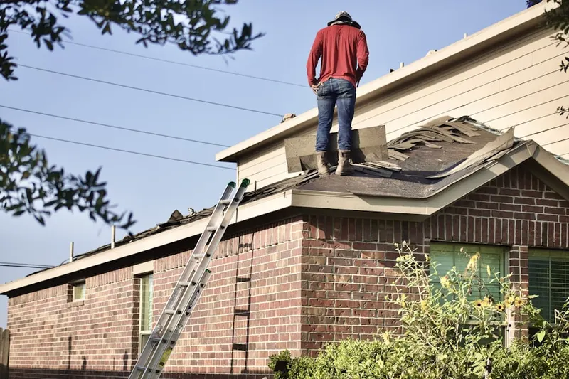 Professional roofer working on a residential roof in Jewtown